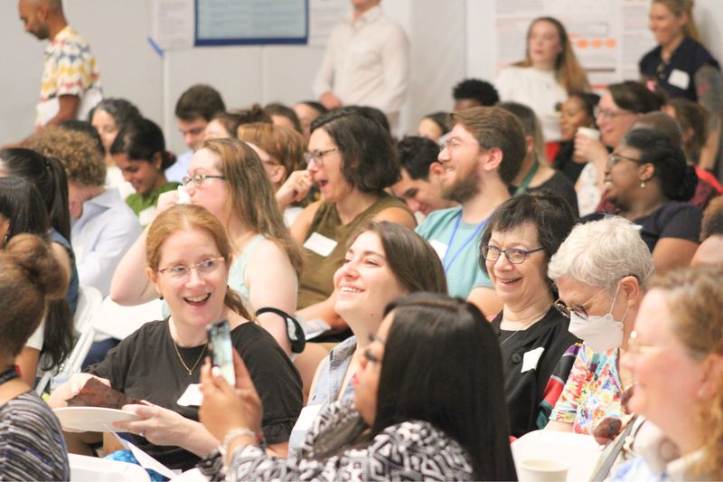 A full room of smiling attendees during a plenary session at the 2025 Street Psychiatry Conference.